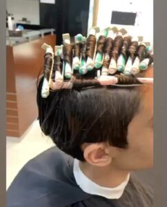 boy with curling rods on the head