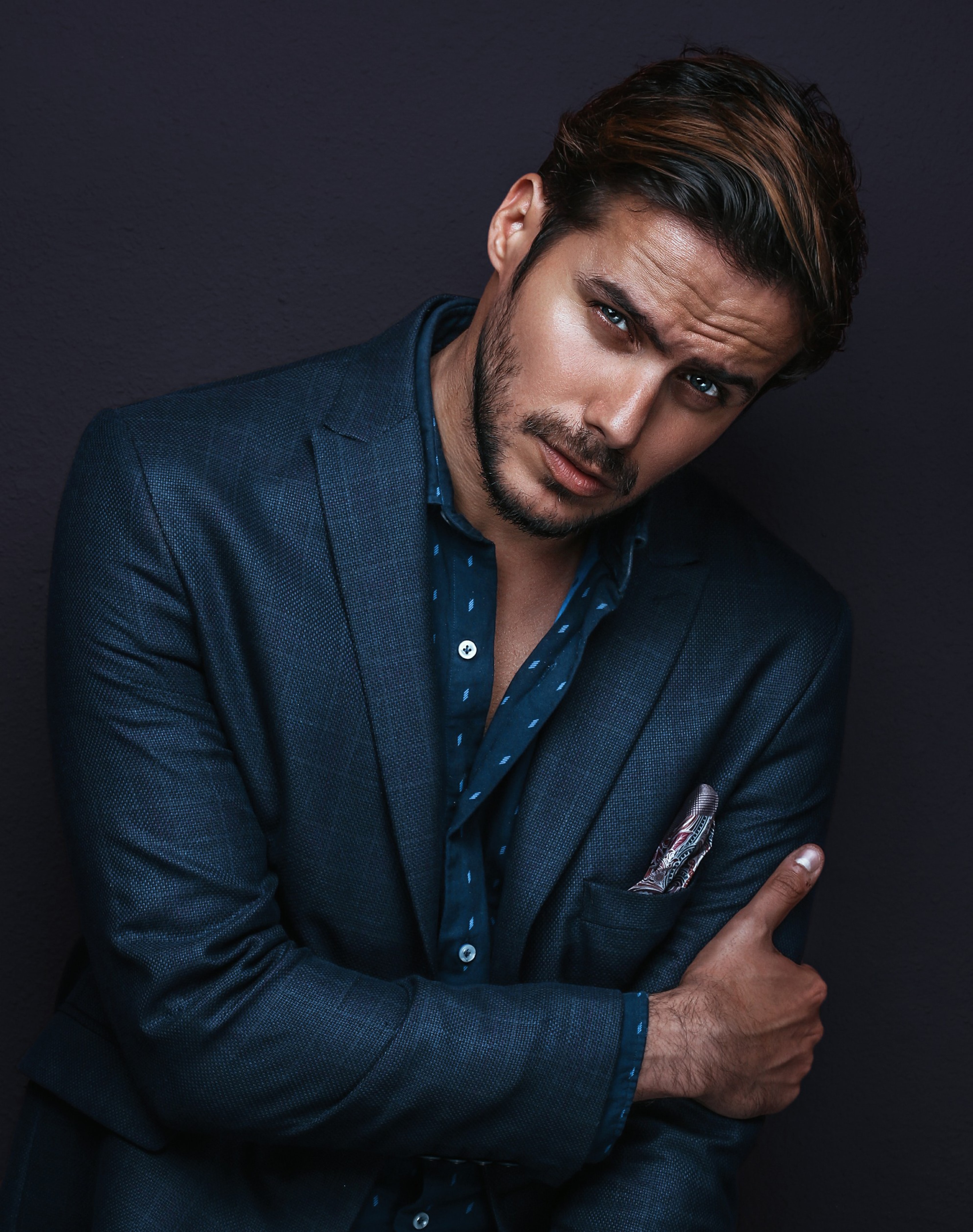 Male model posing wearing a blue suit