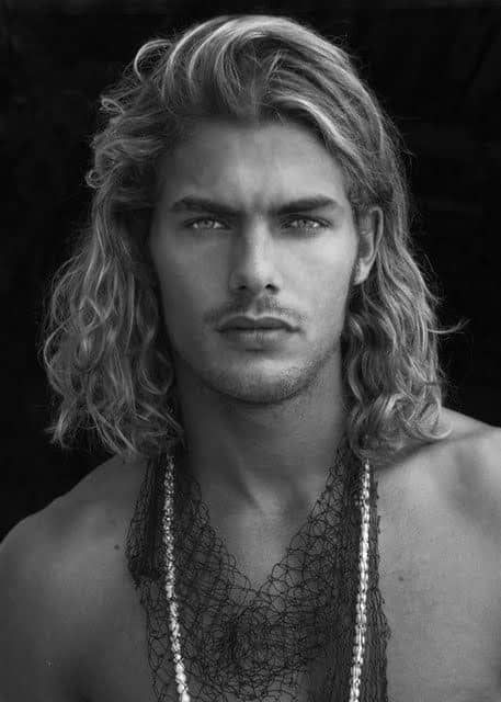 head shot of a man with long hair