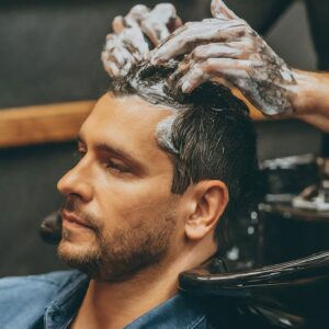 man washing hair in Men's salon