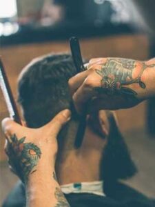 Barber giving a precise haircut at GQ Men's Hair Lounge in JLT Dubai