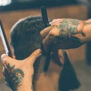 Barber giving a precise haircut at GQ Men's Hair Lounge in JLT Dubai